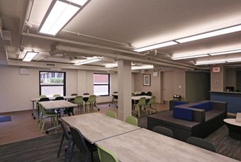 Community Room with long table and windows at Eden Commons, Chicago, IL